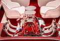 Open loud retro vintage red fiberglass speed boat motor with spark plugs and pipes in back behind seats - boat show