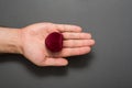 Open male palm with a red heart-shaped jewelry box. Present. Black background Royalty Free Stock Photo