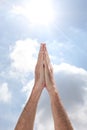 Open man`s hands rising to the sky in a pray gesture with copy space for your text