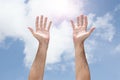 Open man`s hands rising up to the sky