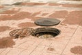 An open manhole on the road. Dangerous open unsecured hatch on the road. Accident with sewer hatch in city. Concept of sewage,