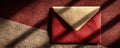 Open maroon envelope with light shadows on textured abstract background Royalty Free Stock Photo