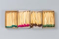 Open matchboxes with wooden household matches with heads different colors Royalty Free Stock Photo