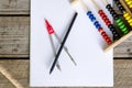 Open math notebook with colored counting abacus and steel compass and pencil on wood