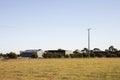 Open Meadow Leading Up To Farm Sheds