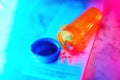 Medication bottle with pills neon glow