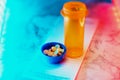 Medication bottle with pills neon glow