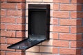 Open metal mailbox on brick wall. Close-up. Selective focus Royalty Free Stock Photo