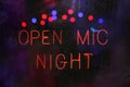 Open Mic Night Sign in Wet Rainy Window