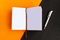 Open mockup notepad on geometric orange and black background