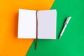 Open mockup notepad on geometric orange and green background