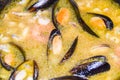 Open mussels in orange broth cooking in a frying pan Royalty Free Stock Photo