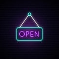 Open neon sign in a frame on brick wall background. Royalty Free Stock Photo