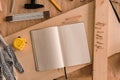 Open note book with blank pages in carpentry workshop Royalty Free Stock Photo