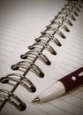 Open note book and metal spiral binding with pen view Royalty Free Stock Photo