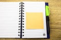 Open note book with stickies on wooden background. 3D illustration