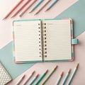 Open notebook with blank pages surrounded by colorful pencils on a pastel background for writing and creativity Royalty Free Stock Photo