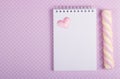 Open notebook with a blank page, marshmallow stick and little valentine Royalty Free Stock Photo