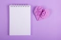 Open notebook with a blank page and origami heart. Valentine paper. Lilac paper heart. Royalty Free Stock Photo