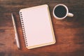 open notebook with blank pages next to cup of coffee Royalty Free Stock Photo