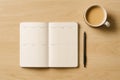 Open notebook with blank pages, pen, and coffee cup on desk Royalty Free Stock Photo