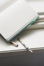 Open notebook with blank pages and a pen on a windowsill Royalty Free Stock Photo