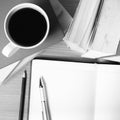 Open notebook with book and coffee cup black and white color to Royalty Free Stock Photo
