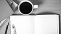 Open notebook with book and coffee cup black and white color to Royalty Free Stock Photo