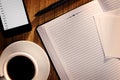 Open notebook with coffee alongside a phone