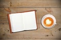 Open notebook with cup of coffee Royalty Free Stock Photo