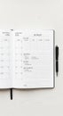 Open notebook displaying a monthly budget planner and calendar layout on a white Royalty Free Stock Photo