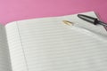 Open notebook, empty page for text, on pink background. space for text. Office, business or education concept Royalty Free Stock Photo