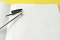 Open notebook, empty page for text, on yellow background. space for text. Office, business or education concept Royalty Free Stock Photo