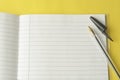Open notebook, empty page for text, on yellow background. space for text. Office, business or education concept Royalty Free Stock Photo