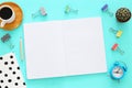 Open notebook with empty pages and other office supplies over blue office desk table. Top view Royalty Free Stock Photo