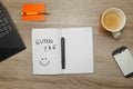 Open notebook with German text `GUTEN TAG` Good afternoon and a cup of coffee on wooden background. Royalty Free Stock Photo