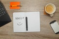 Open notebook with German word `HALLO` Hello and a cup of coffee on wooden background. Royalty Free Stock Photo