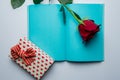 Open notebook,gift box, rose and red hearts on a white background Royalty Free Stock Photo