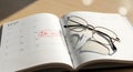 Open notebook with glasses and handwritten mathematical equation Royalty Free Stock Photo