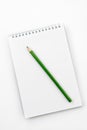 Open notebook with green Graphite pencil on white Royalty Free Stock Photo