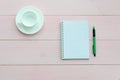 Open notebook with green pen and coffee cup Royalty Free Stock Photo