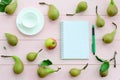 Open notebook with green pen, coffee cup and pears Royalty Free Stock Photo