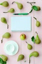 Open notebook with green pen, coffee cup and pears Royalty Free Stock Photo