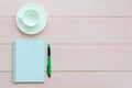 Open notebook with green pen and coffee cup Royalty Free Stock Photo