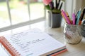 Open Notebook With Handwritten To-Do List and Pens in a Silver Holder Royalty Free Stock Photo