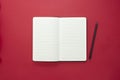 Open notebook isolated on red background, copy space for text Royalty Free Stock Photo
