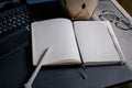 Open notebook with laptop on a black table Royalty Free Stock Photo