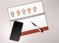 An open notebook in leather binding with a smartphone and pen on a gray background. Royalty Free Stock Photo