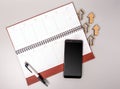 An open notebook in leather binding with a smartphone and pen on a gray background. Royalty Free Stock Photo