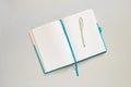 Open notebook with lined blank pages and pen on light grey background. Copy space, top view